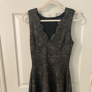 AQUA Black with gold sparkle/shimmer, scalloped neckline, falls above knee